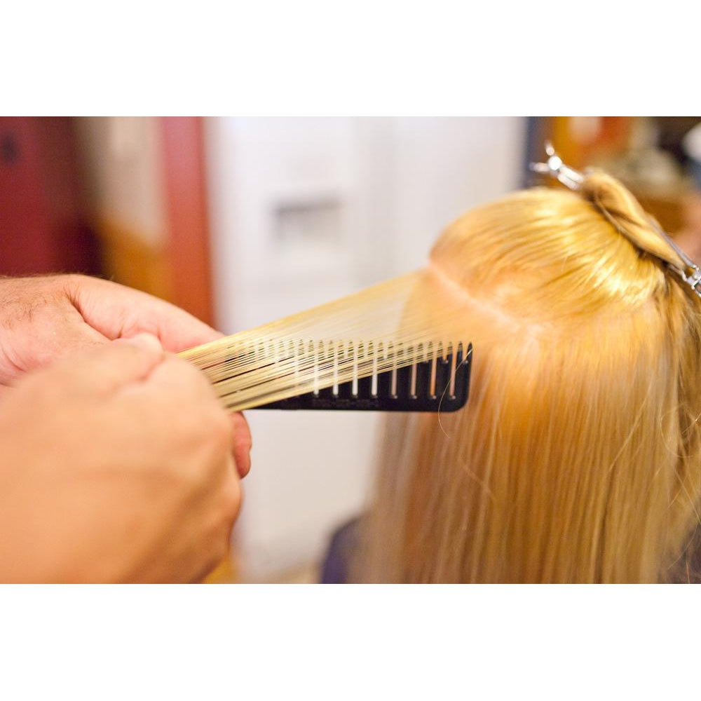 Person demonstrating step #3 in using the Highlighting and foiling comb to easily color hair
