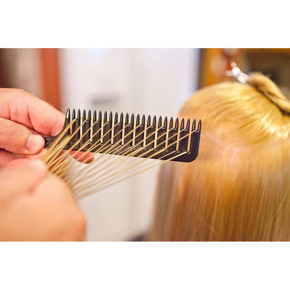 Person demonstrating step #4 in using the Highlighting and foiling comb to easily color hair