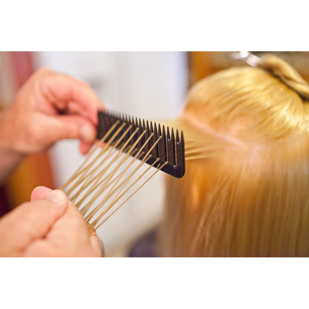 Person demonstrating step #2 in using the Highlighting and foiling comb to easily color hair